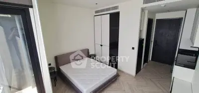 Modern bedroom with sleek design and ample storage in a contemporary apartment.