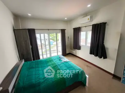 Spacious bedroom with modern decor and balcony access