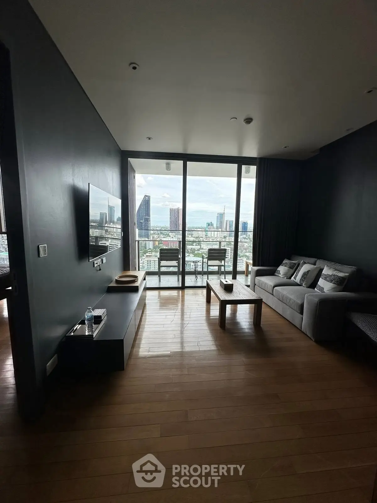 Modern living room with city view and sleek furnishings