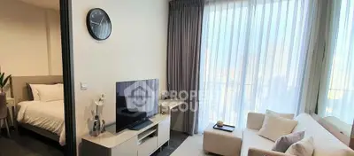 Modern living room with large window and adjacent bedroom, featuring sleek furniture and neutral tones.