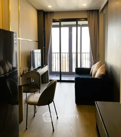 Modern living room with balcony view, sleek furniture, and natural light.
