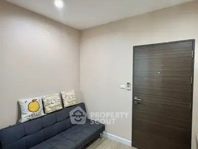 Cozy small living room with modern sofa and stylish door