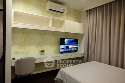 Modern bedroom with built-in desk, air conditioning, and wall-mounted TV, perfect for comfort and productivity.