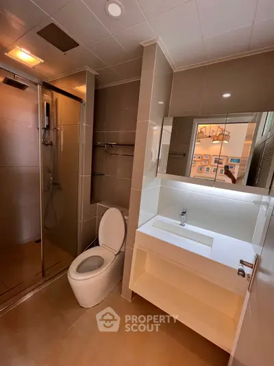 Modern bathroom with sleek fixtures and glass shower enclosure