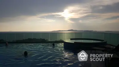 Stunning rooftop pool with panoramic ocean view at sunset