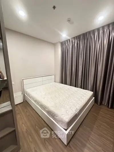 Modern bedroom with sleek design and wooden flooring