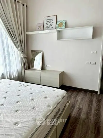 Modern minimalist bedroom with stylish decor and natural light