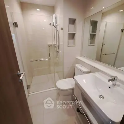 Modern bathroom with glass shower and sleek fixtures