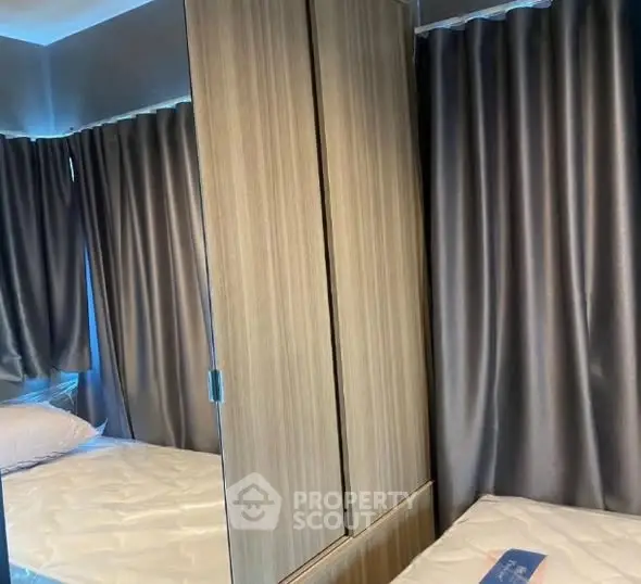 Cozy bedroom with mirrored wardrobe and elegant curtains