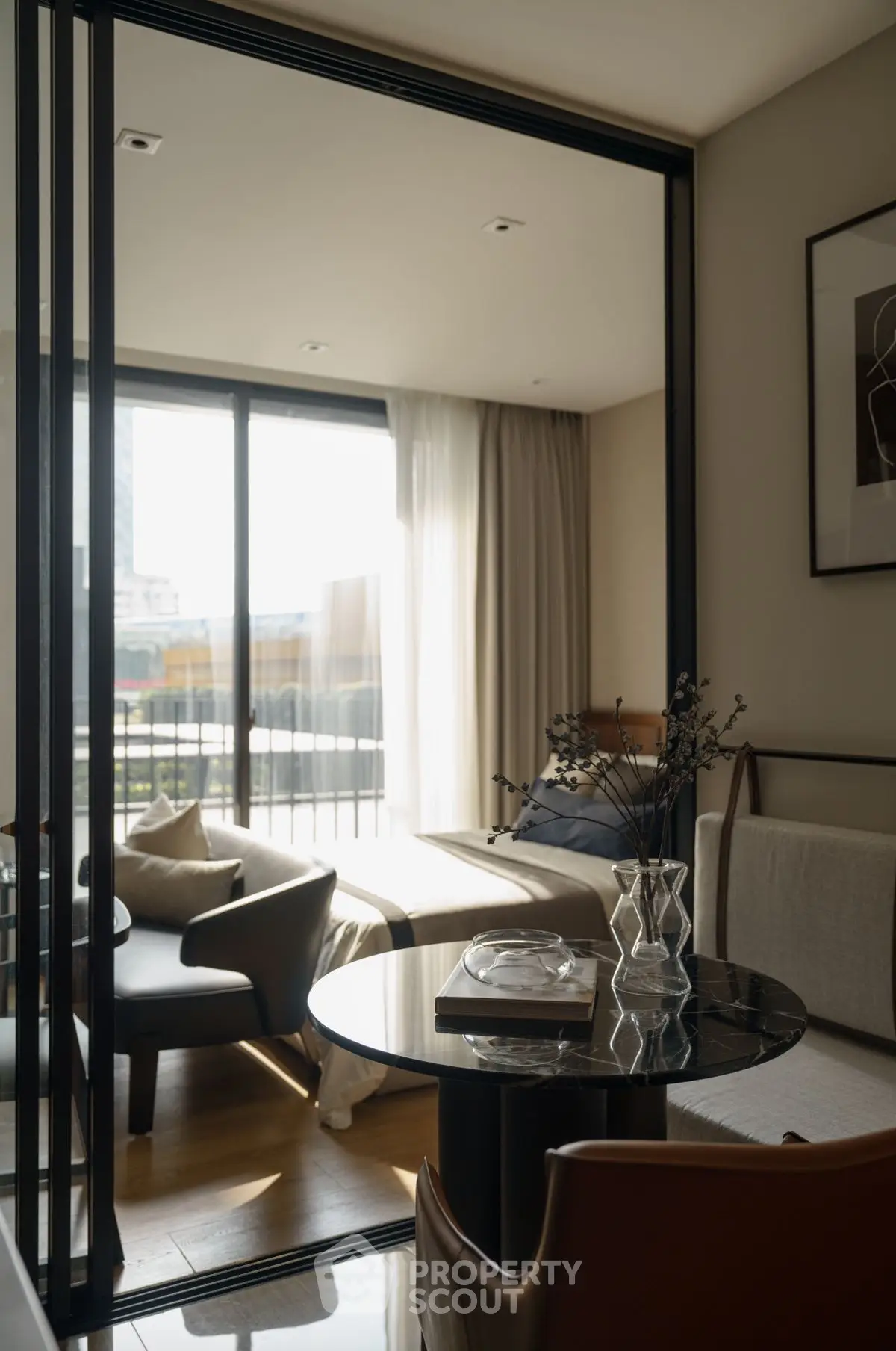 Stylish modern living room with elegant furniture and large windows offering city views.