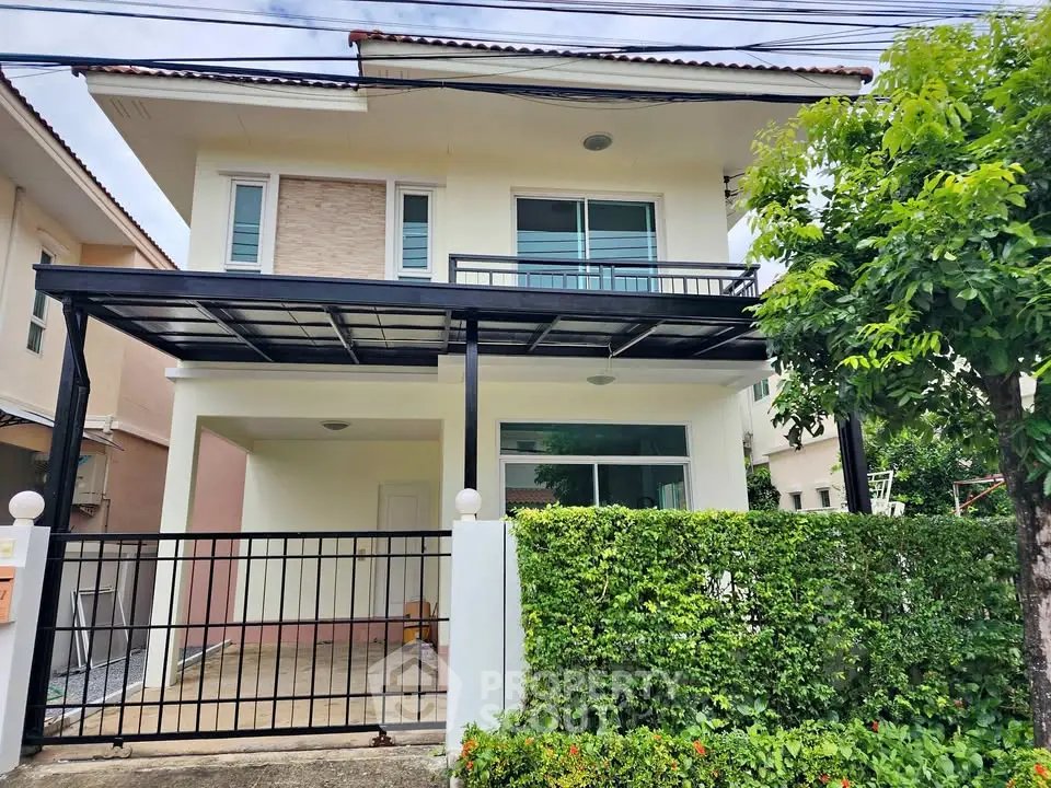 Charming two-story house with modern design and lush greenery in a serene neighborhood.