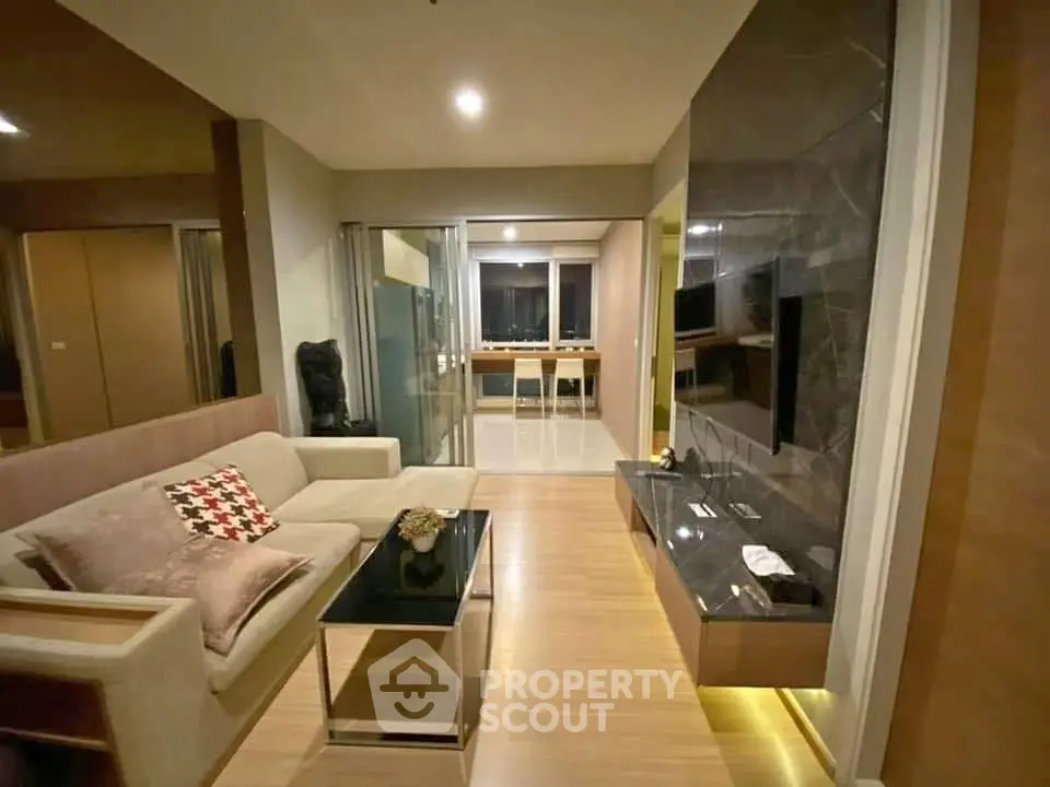 Modern living room with sleek design and open layout, featuring a cozy sofa and stylish decor.