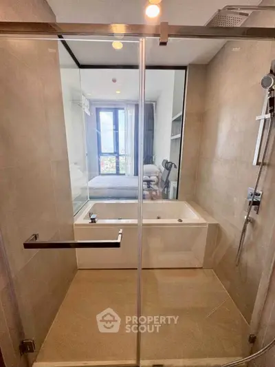 Modern bathroom with glass shower and bathtub in a stylish apartment.