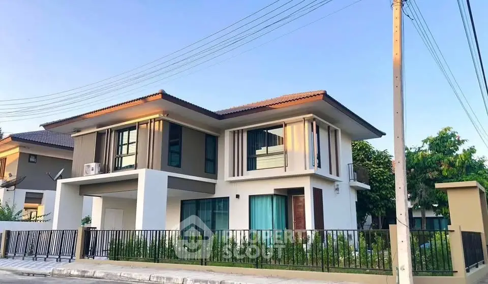 Modern two-story house with sleek design and large windows in a serene neighborhood.