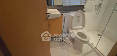 Modern bathroom with sleek fixtures and glass shower enclosure