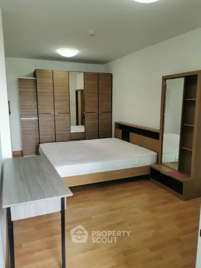 Spacious bedroom with modern furniture and ample storage space