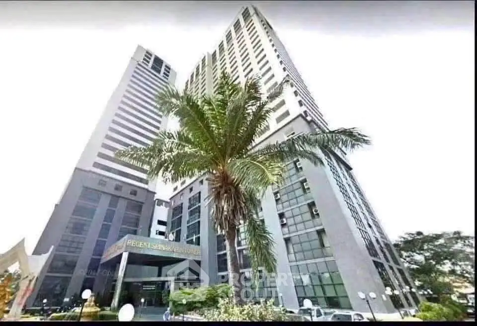 Stunning high-rise building with modern architecture and lush landscaping.