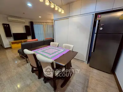 Modern dining area with stylish table, chairs, and open living room view.