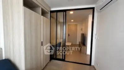 Modern apartment interior with sliding glass doors and wooden flooring