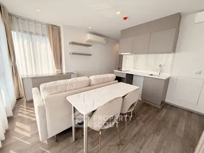 Modern open-plan living room with sleek kitchen and elegant dining area