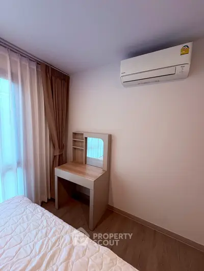Cozy bedroom with air conditioning and elegant vanity table, perfect for relaxation and comfort.