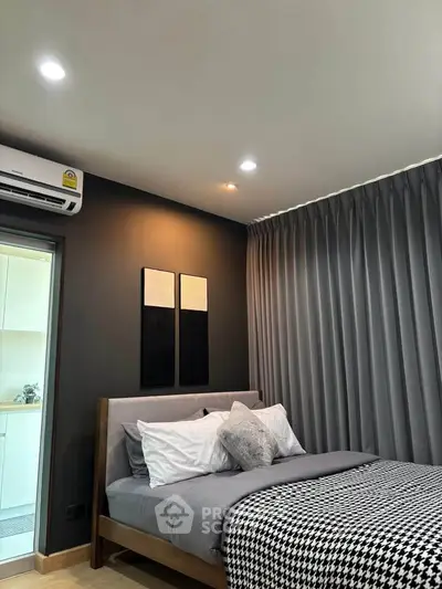 Modern bedroom with stylish decor and cozy ambiance in a contemporary apartment.