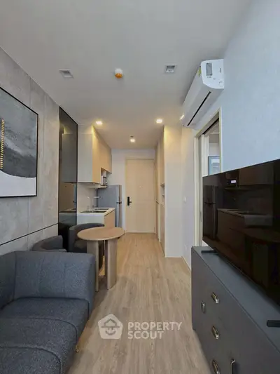 Modern living room with open kitchen layout and stylish decor