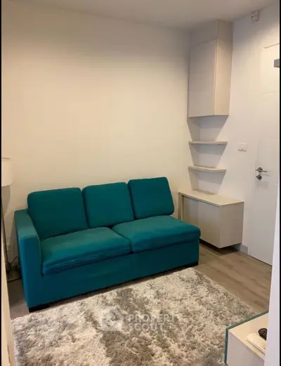 Cozy living room with teal sofa and modern shelving