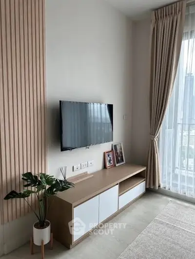 Modern living room with wall-mounted TV and city view window