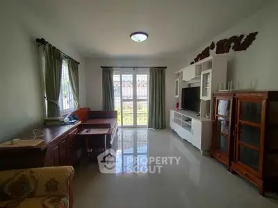 Spacious living room with elegant furniture and large windows offering natural light