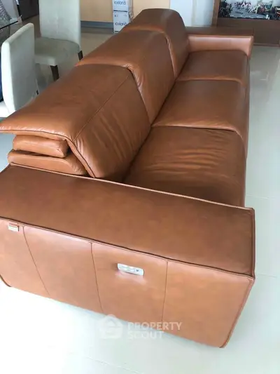 Luxurious brown leather sofa in modern living room setting, perfect for stylish comfort and elegance.