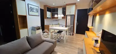 Modern living room with open kitchen, sleek furniture, and stylish decor