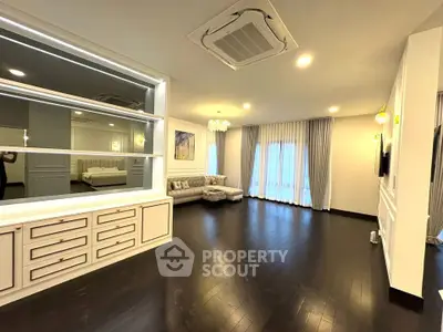 Spacious modern living room with elegant decor and large windows