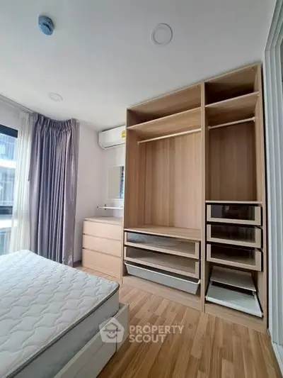Spacious bedroom with built-in wooden wardrobe and natural light