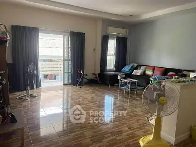 Spacious living room with modern decor and large windows for natural light.