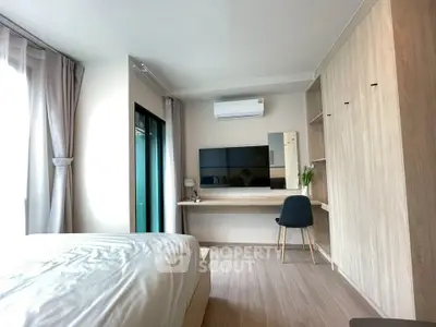 Modern bedroom with sleek design, featuring built-in wardrobe and work desk, perfect for urban living.
