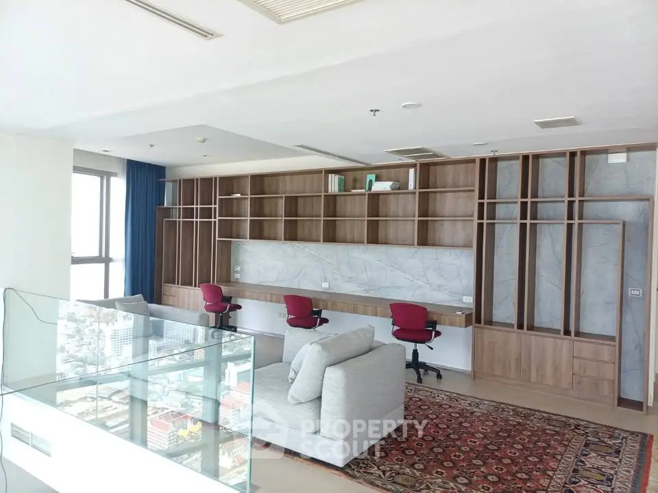 Spacious modern study room with city view, featuring built-in shelves, desks, and comfortable seating.