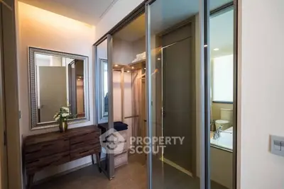 Modern bedroom with mirrored closet and elegant wooden furniture