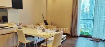 Modern living room with dining area and city view balcony in luxury apartment.