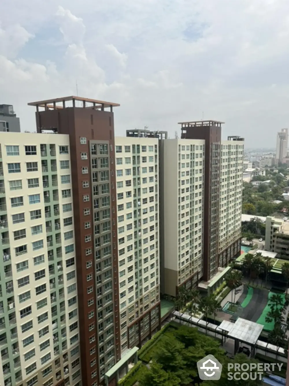 Stunning high-rise apartment building with panoramic city views and lush greenery