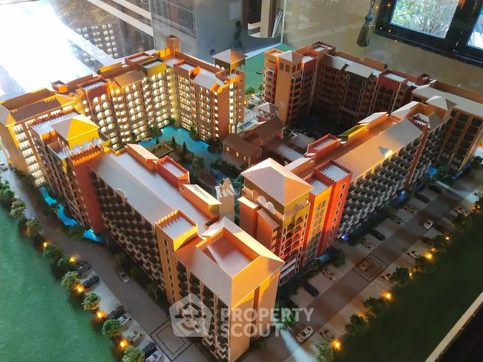 Stunning architectural model of a modern residential complex with vibrant lighting and detailed landscaping.