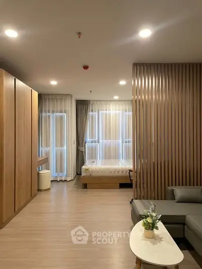 Modern studio apartment with stylish wooden accents and cozy living area.