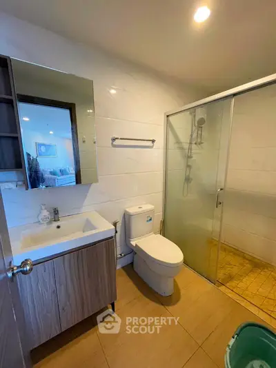 Modern bathroom with glass shower and stylish vanity in contemporary home.