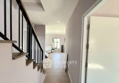 Bright hallway leading to a cozy living room with modern decor