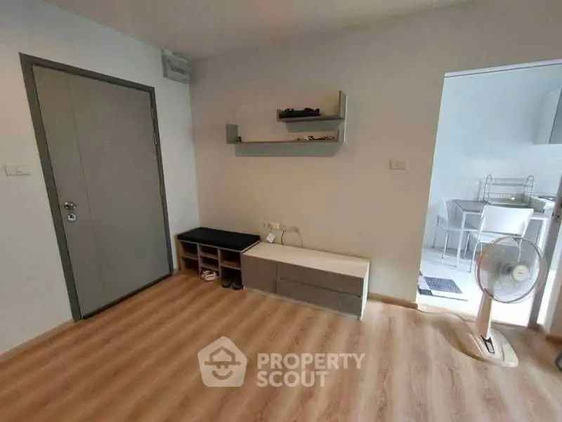 Modern apartment entrance with wooden flooring and minimalist decor