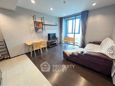 Spacious modern living room with large window and stylish furniture