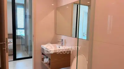 Modern bathroom with sleek design and wooden accents in a contemporary apartment.