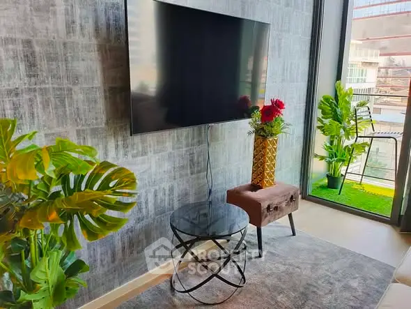 Modern living room with wall-mounted TV, stylish decor, and large window with balcony view.