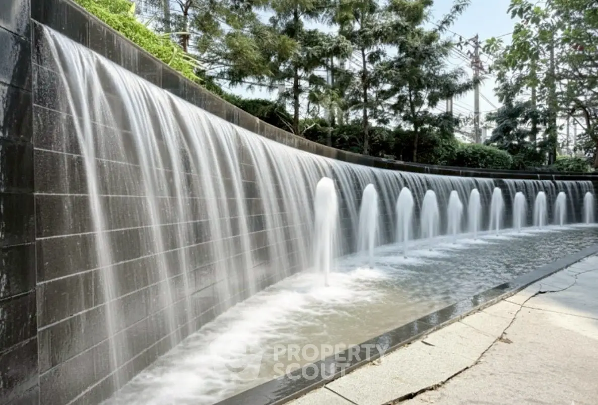 Stunning outdoor water feature with cascading waterfall in a modern landscaped garden.