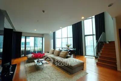 Luxurious modern living room with high ceilings and large windows in a stylish apartment.